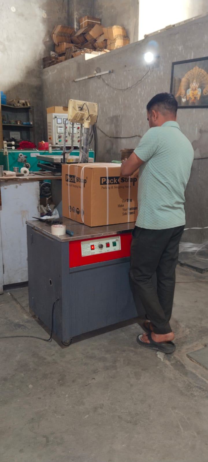 Strapping machine in use - industrial packaging